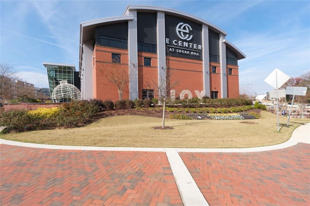 4180 Chatham Ridge Drive Buford, GA 30518 - Photo 35 of 43 a view of a brick building with large windows