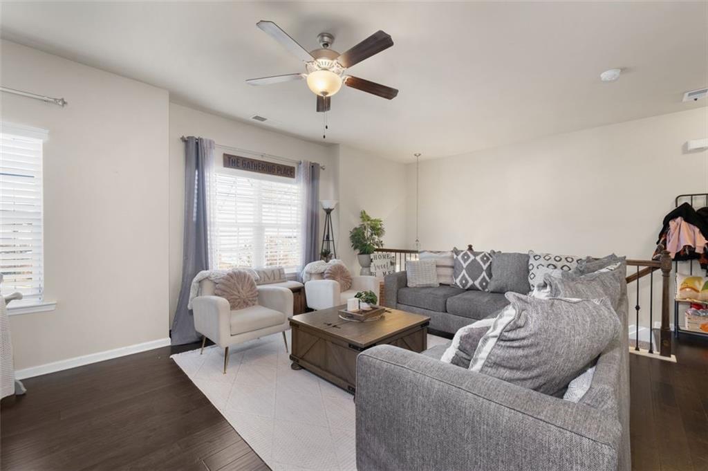 4180 Chatham Ridge Drive Buford, GA 30518 - Photo 6 of 43 a living room with furniture and a large window