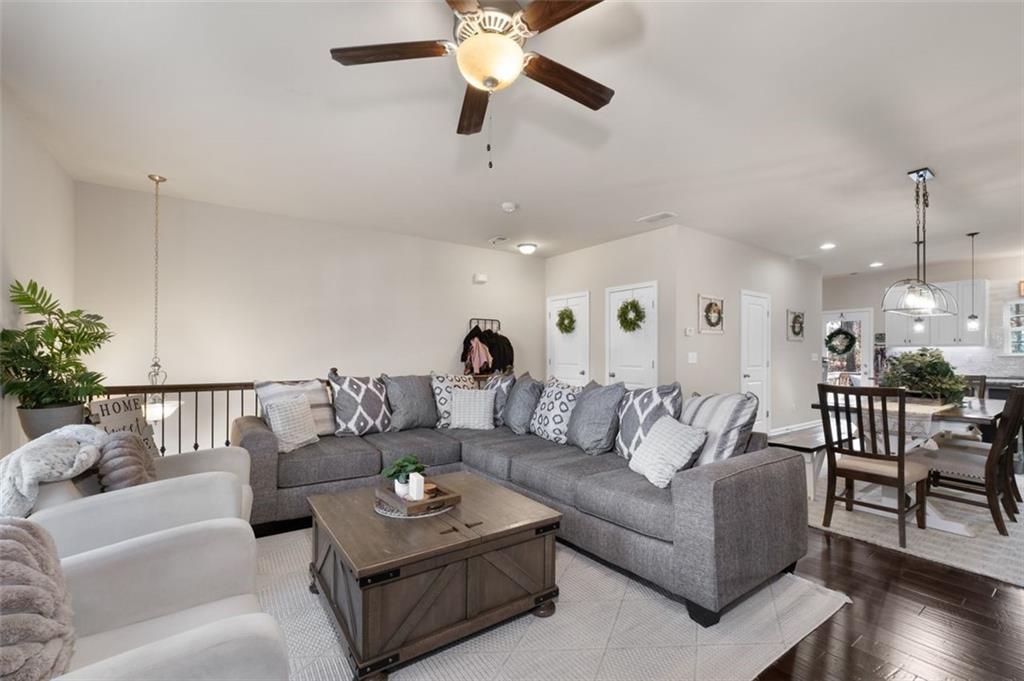 4180 Chatham Ridge Drive Buford, GA 30518 - Photo 7 of 43 a living room with furniture and a chandelier