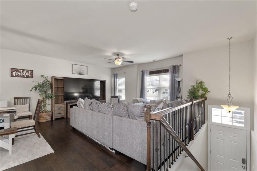 4180 Chatham Ridge Drive Buford, GA 30518 - Photo 9 of 43 a living room with furniture a flat screen tv and a fireplace