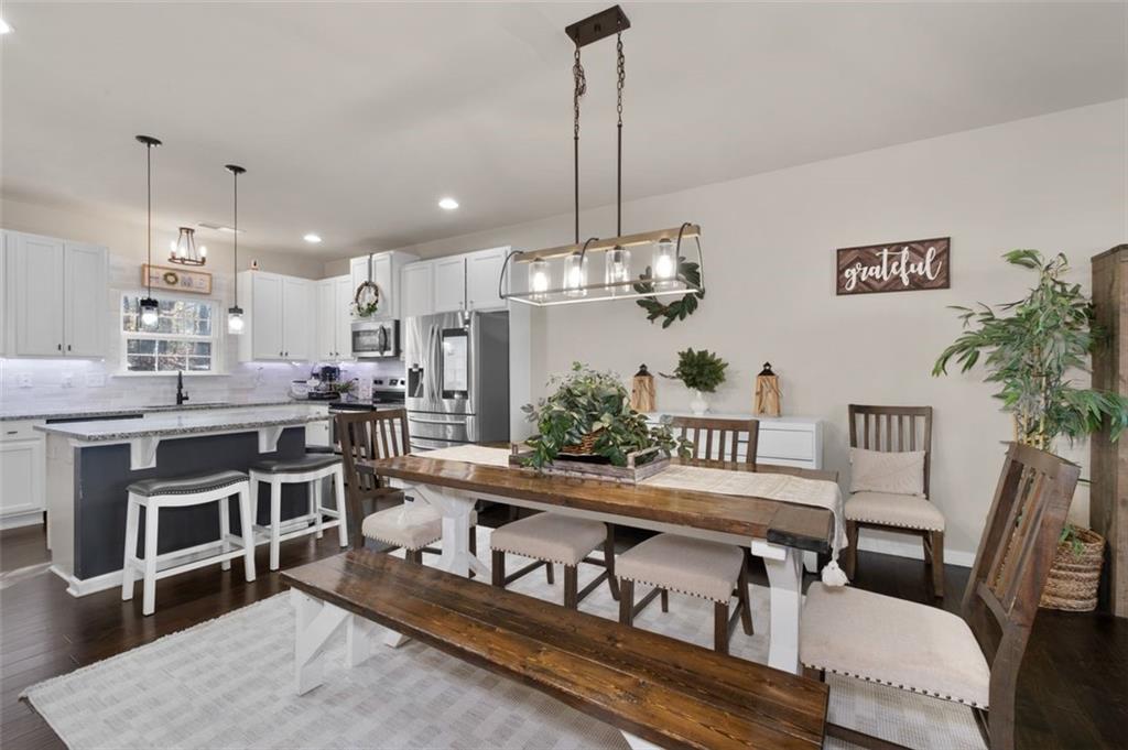 4180 Chatham Ridge Drive Buford, GA 30518 - Photo 10 of 43 a large kitchen with a table and chairs