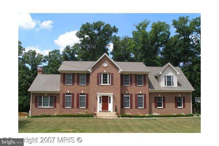 7201 Wesley Road Springfield, VA 22150 - Photo 1 of 11 a front view of a house with a yard