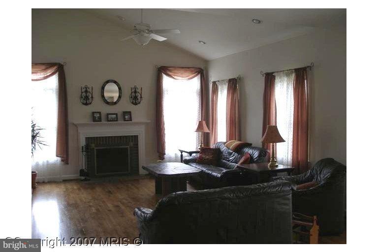 7201 Wesley Road Springfield, VA 22150 - Photo 4 of 11 a living room with furniture and a fireplace