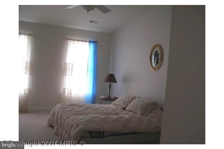 7201 Wesley Road Springfield, VA 22150 - Photo 10 of 11 a bedroom with a bed and a window