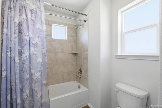a bath room with a toilet and a bath tub
