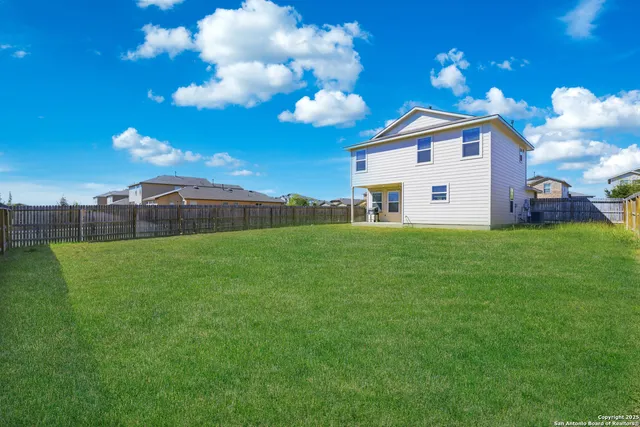 a view of a house with a backyard