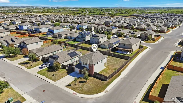 an aerial view of residential houses with outdoor space