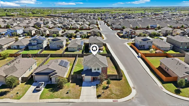 an aerial view of residential houses with outdoor space