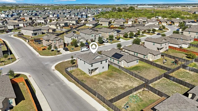 an aerial view of residential houses with outdoor space