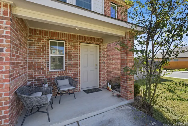 a backyard of a house with outdoor seating