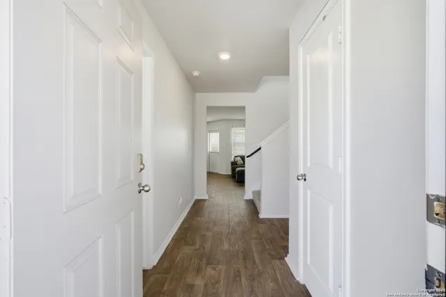 a view of a hallway with a wooden floor