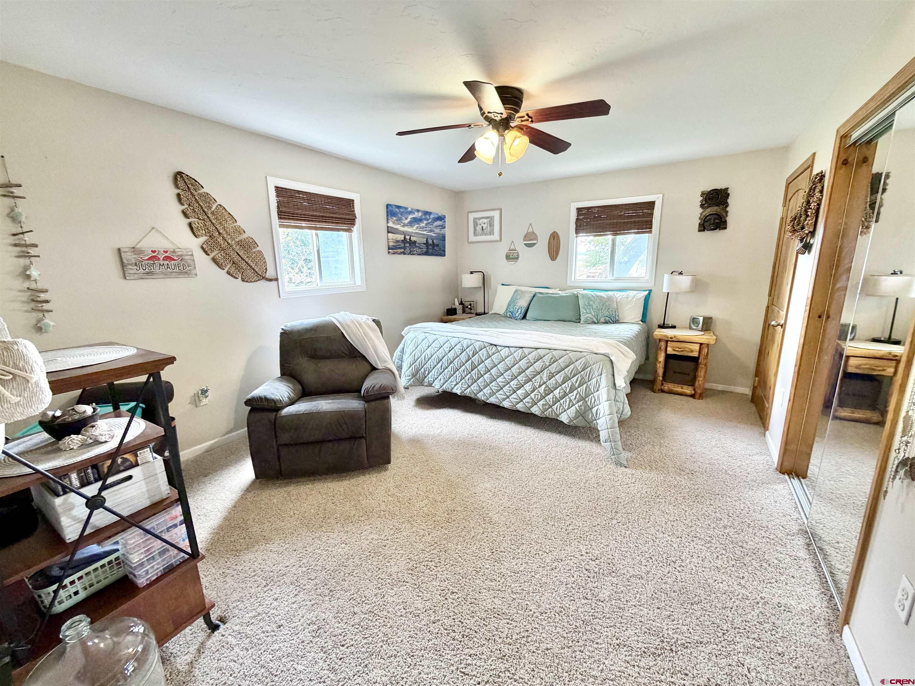 3998 5500th Road Olathe, CO 81425 - Photo 21 of 45 a bedroom with a bed a couch and a window