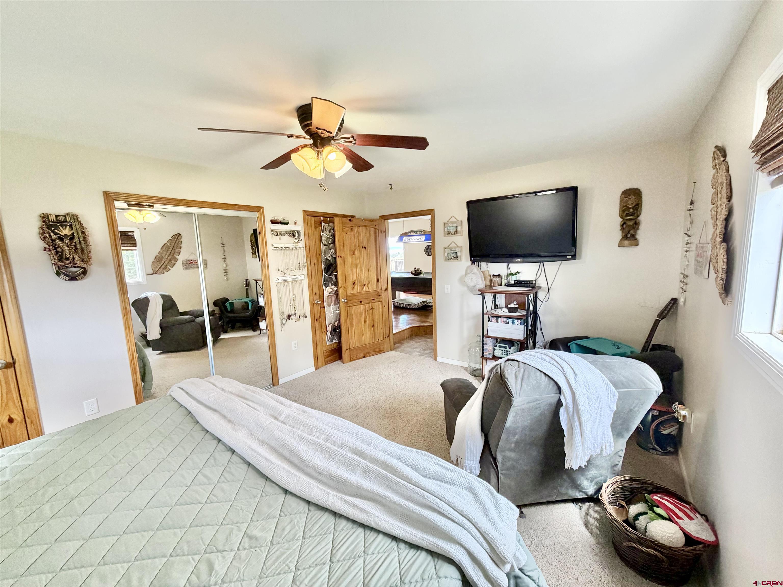 3998 5500th Road Olathe, CO 81425 - Photo 22 of 45 a bedroom with a bed and a flat screen tv