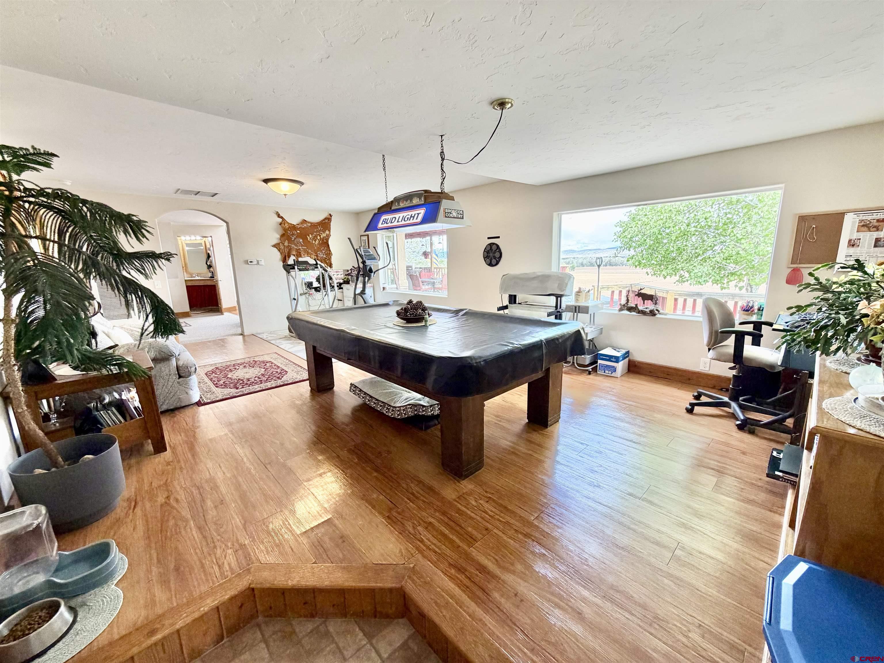 3998 5500th Road Olathe, CO 81425 - Photo 23 of 45 a living room with fireplace furniture and a large window