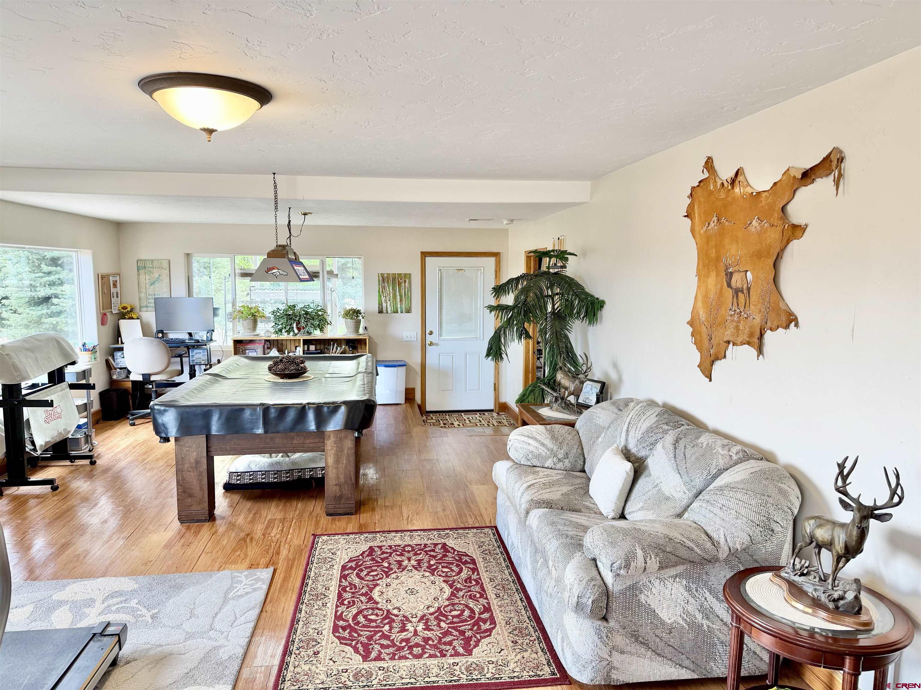 3998 5500th Road Olathe, CO 81425 - Photo 26 of 45 a living room with furniture and a chandelier