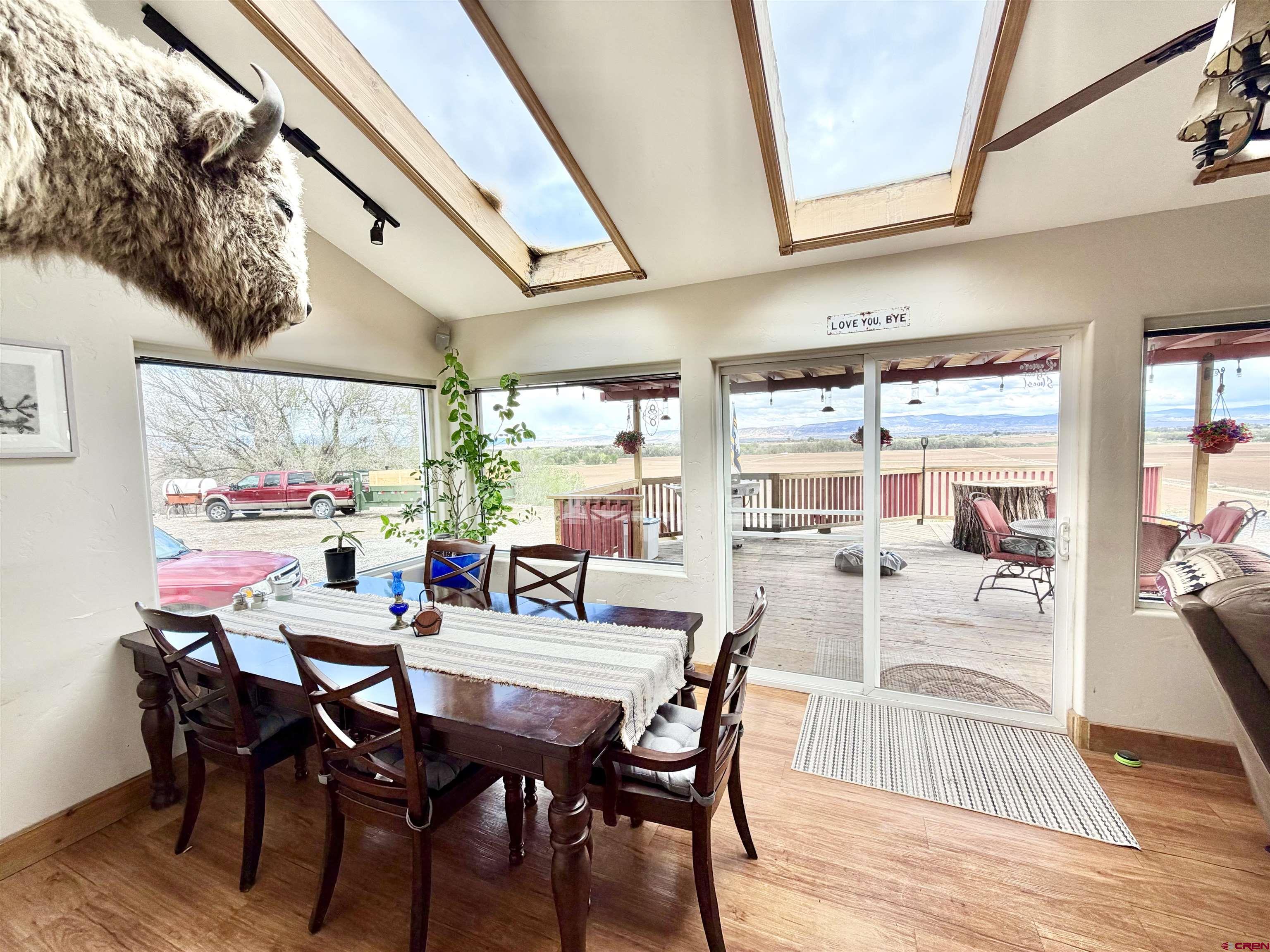 3998 5500th Road Olathe, CO 81425 - Photo 29 of 45 a dining room with furniture and wooden floor