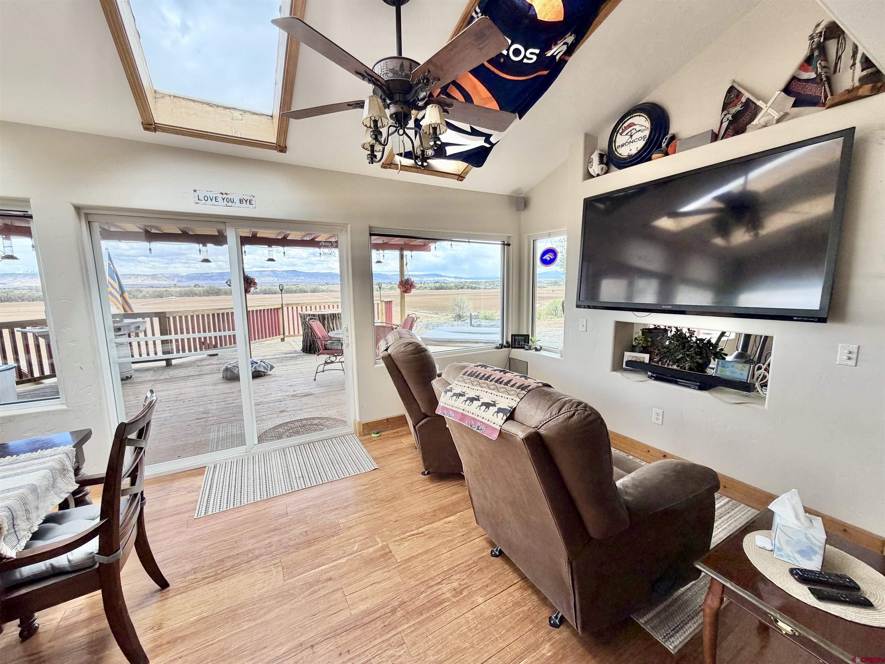 3998 5500th Road Olathe, CO 81425 - Photo 30 of 45 a living room with furniture and a flat screen tv