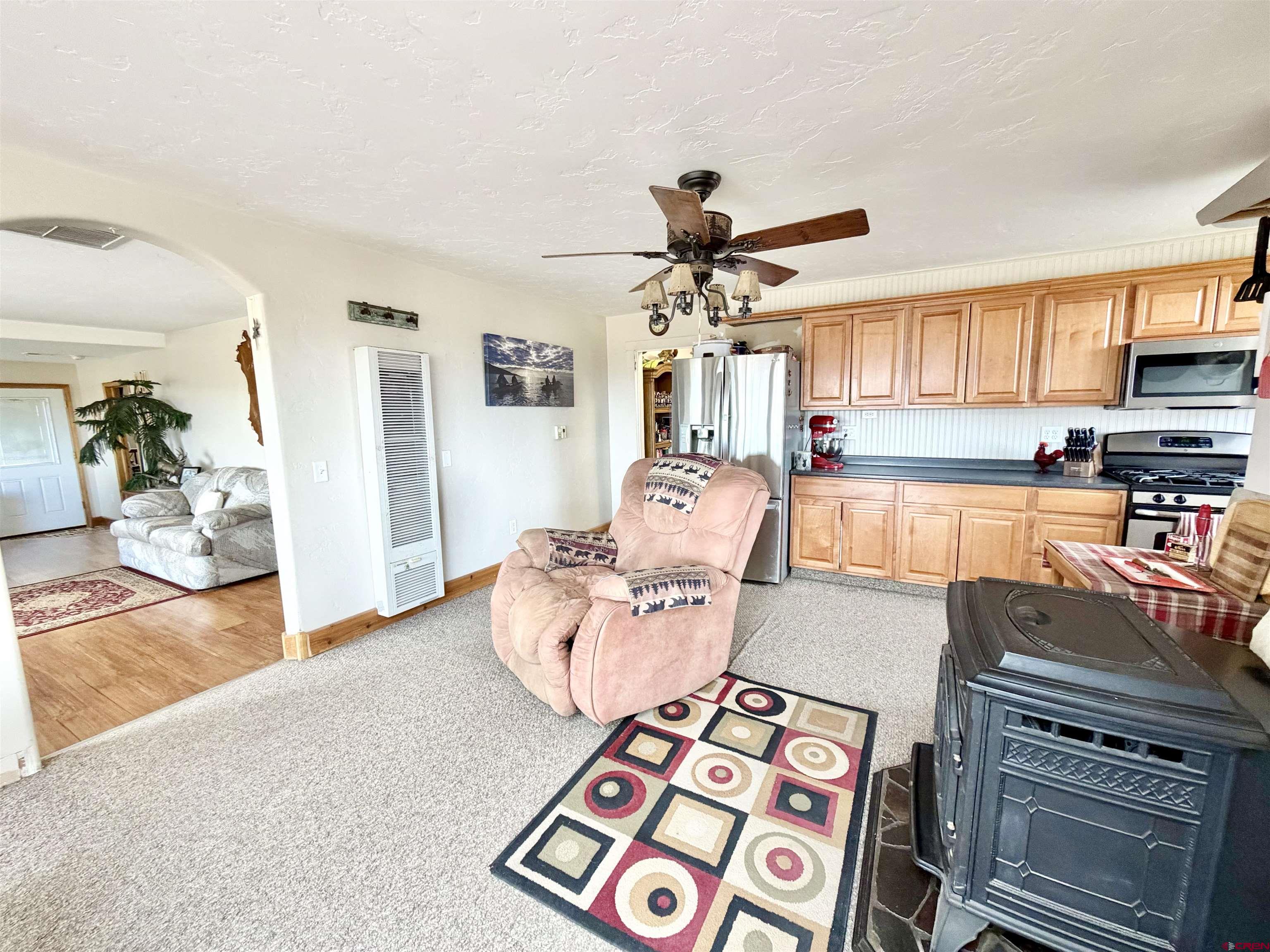 3998 5500th Road Olathe, CO 81425 - Photo 31 of 45 a living room with furniture and a fireplace