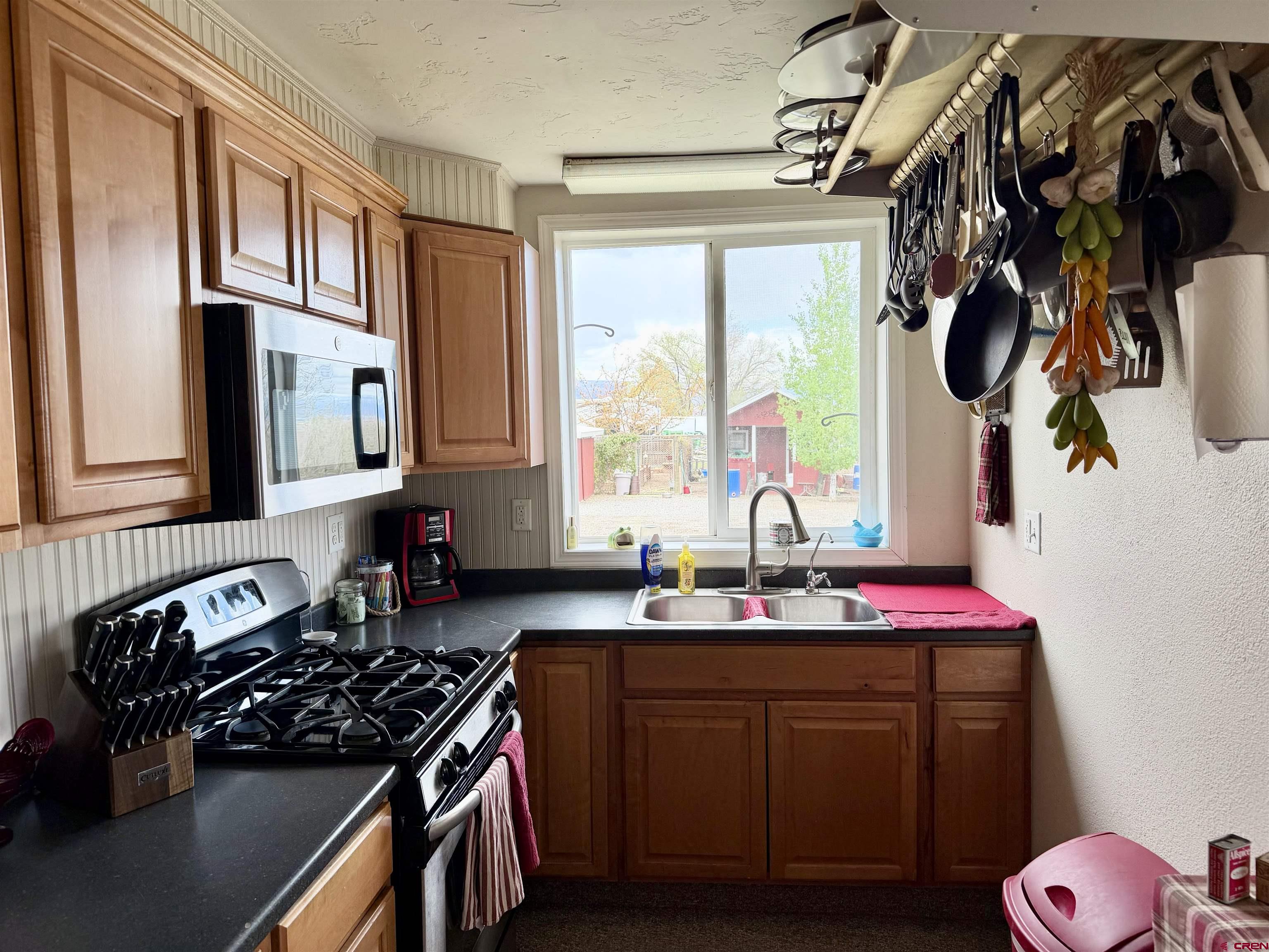 3998 5500th Road Olathe, CO 81425 - Photo 33 of 45 a kitchen with a sink stove and cabinets