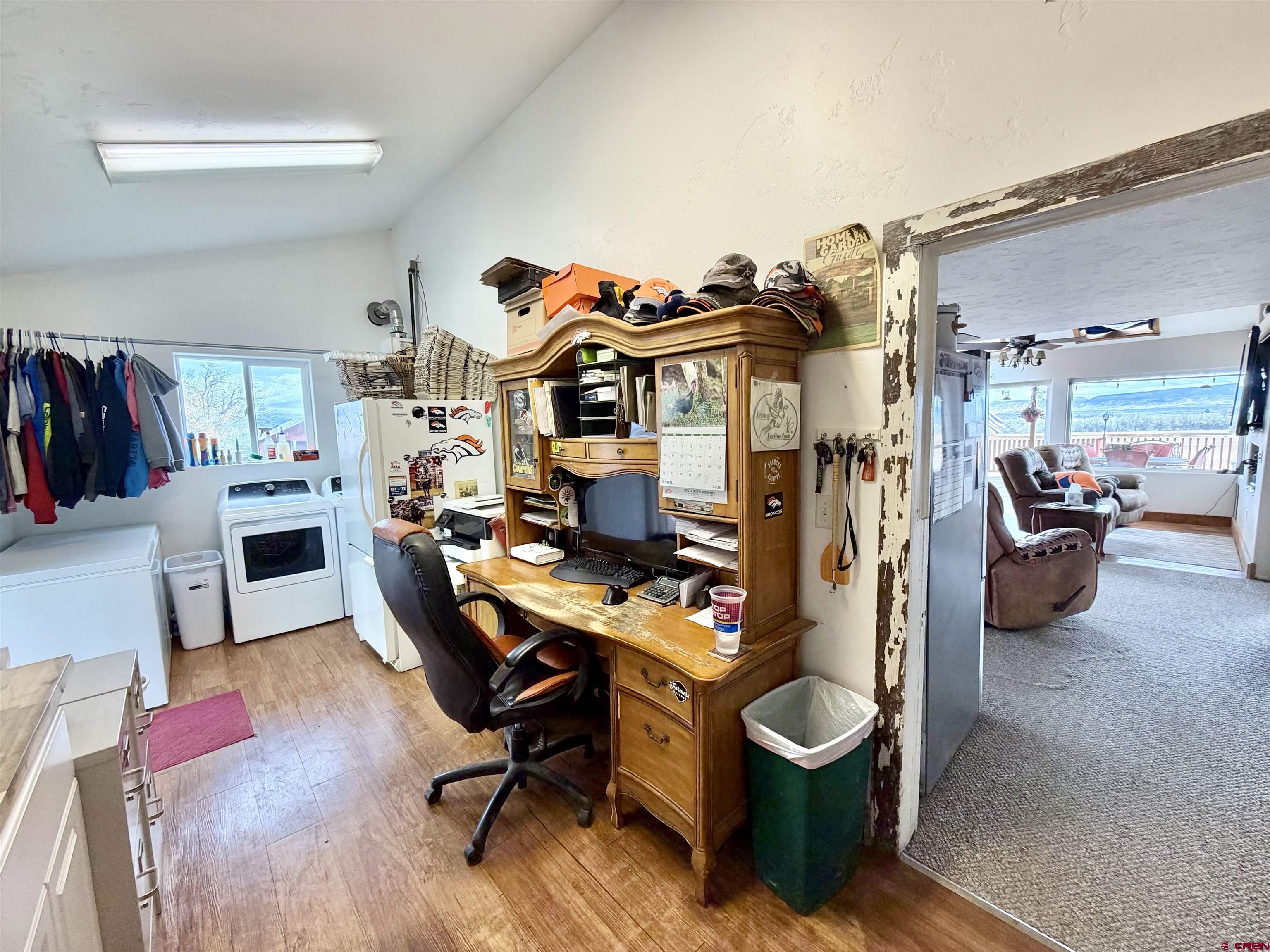 3998 5500th Road Olathe, CO 81425 - Photo 35 of 45 a view of a workspace with furniture and a livingroom
