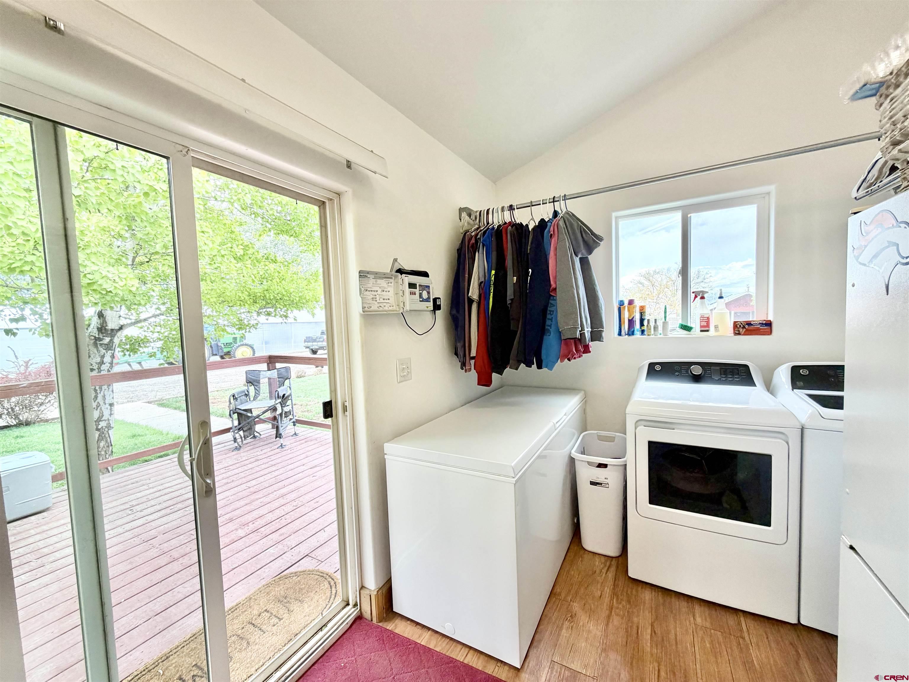 3998 5500th Road Olathe, CO 81425 - Photo 36 of 45 a view of a kitchen with fridge and wooden floor