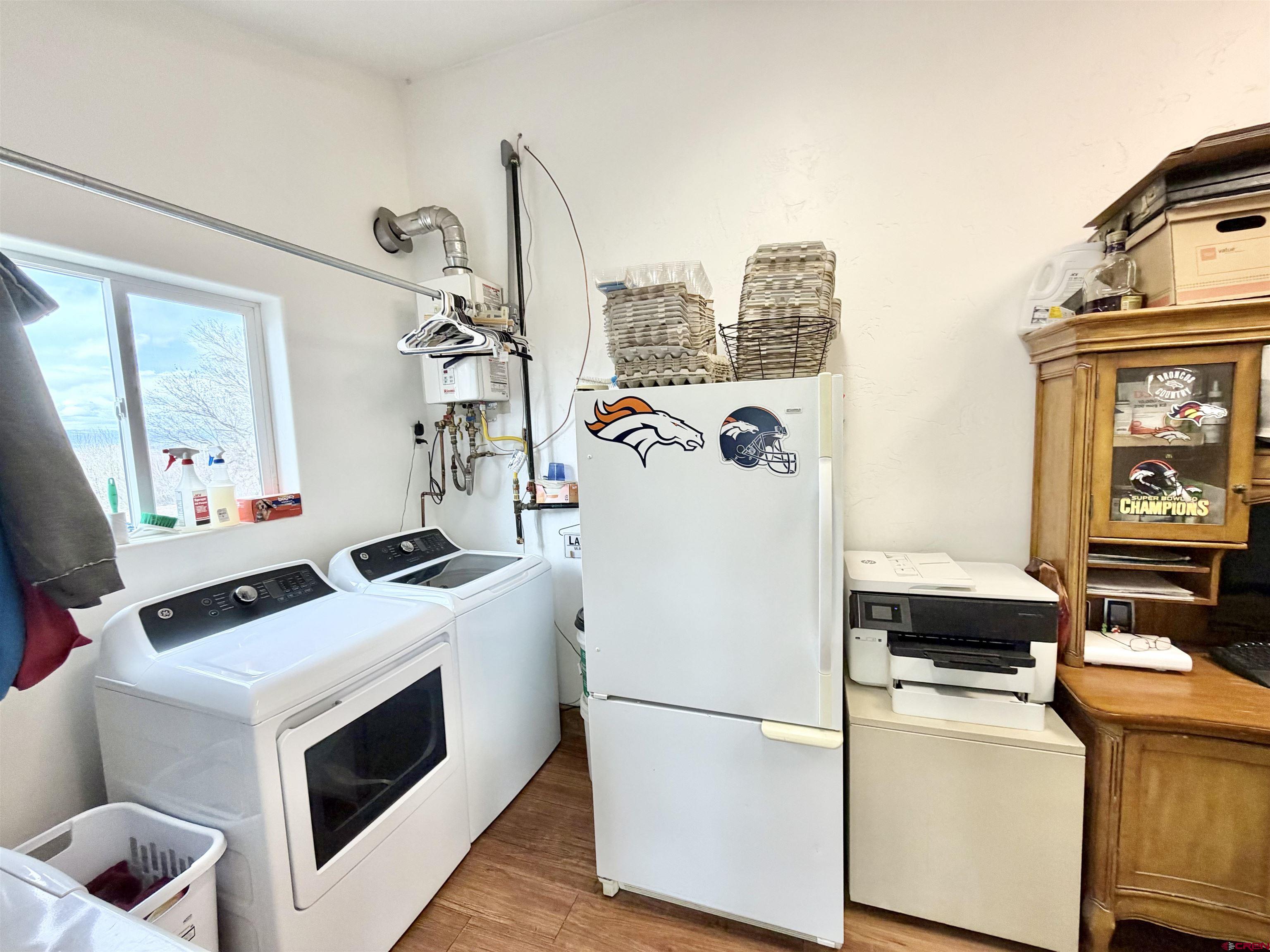 3998 5500th Road Olathe, CO 81425 - Photo 37 of 45 a white refrigerator freezer and a stove sitting inside of a kitchen