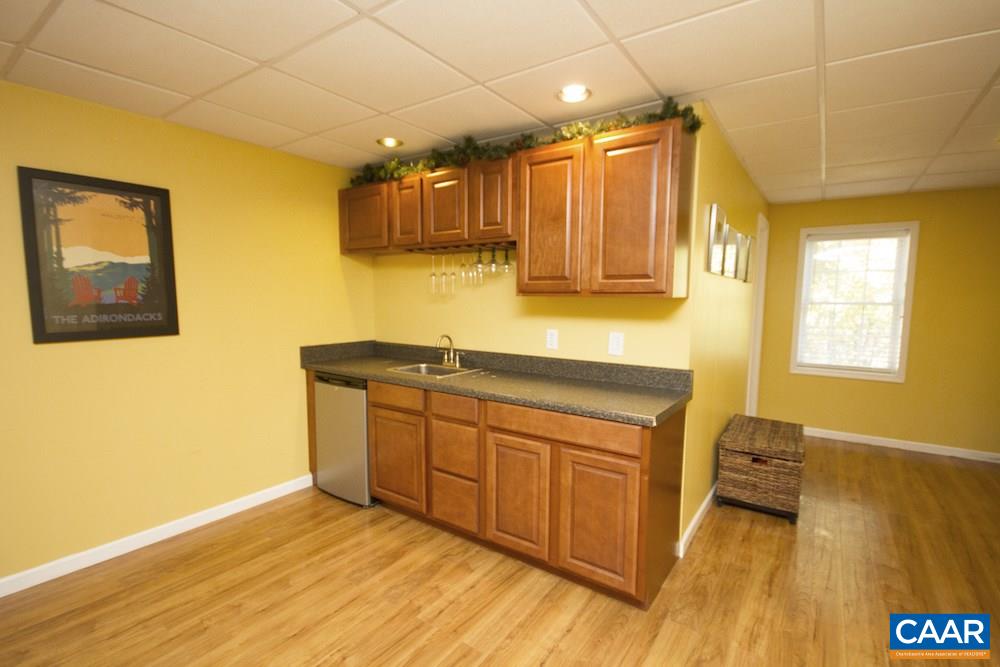 81 Hords Hill Road Ruckersville, VA 22968 - Photo 27 of 34 a kitchen with granite countertop a sink cabinets and wooden floor