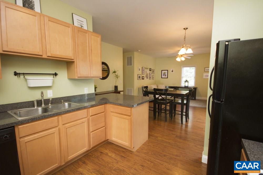 81 Hords Hill Road Ruckersville, VA 22968 - Photo 7 of 34 a kitchen with stainless steel appliances granite countertop a refrigerator a sink a stove and dining table with wooden floor