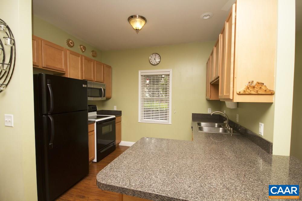 81 Hords Hill Road Ruckersville, VA 22968 - Photo 9 of 34 a kitchen with stainless steel appliances granite countertop a refrigerator a stove and a sink with wooden floor