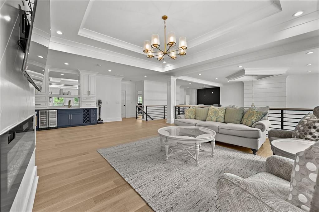 2694 Thompson Mill Road Buford, GA 30519 - Photo 44 of 70 a living room with furniture and a chandelier