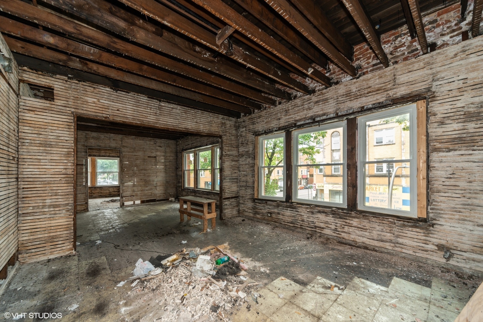 5256 West Chicago Avenue Chicago, IL 60651 - Photo 8 of 11 a view of an empty room with wooden floor and a chair