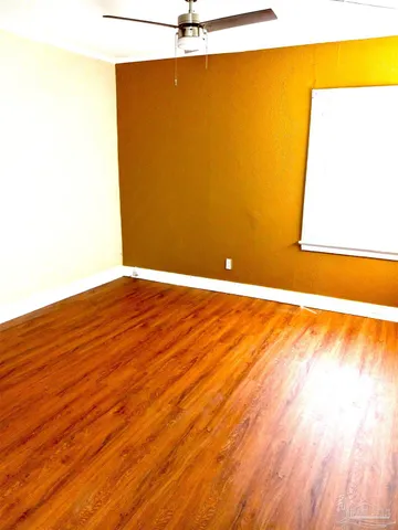 a view of an empty room and wooden floor