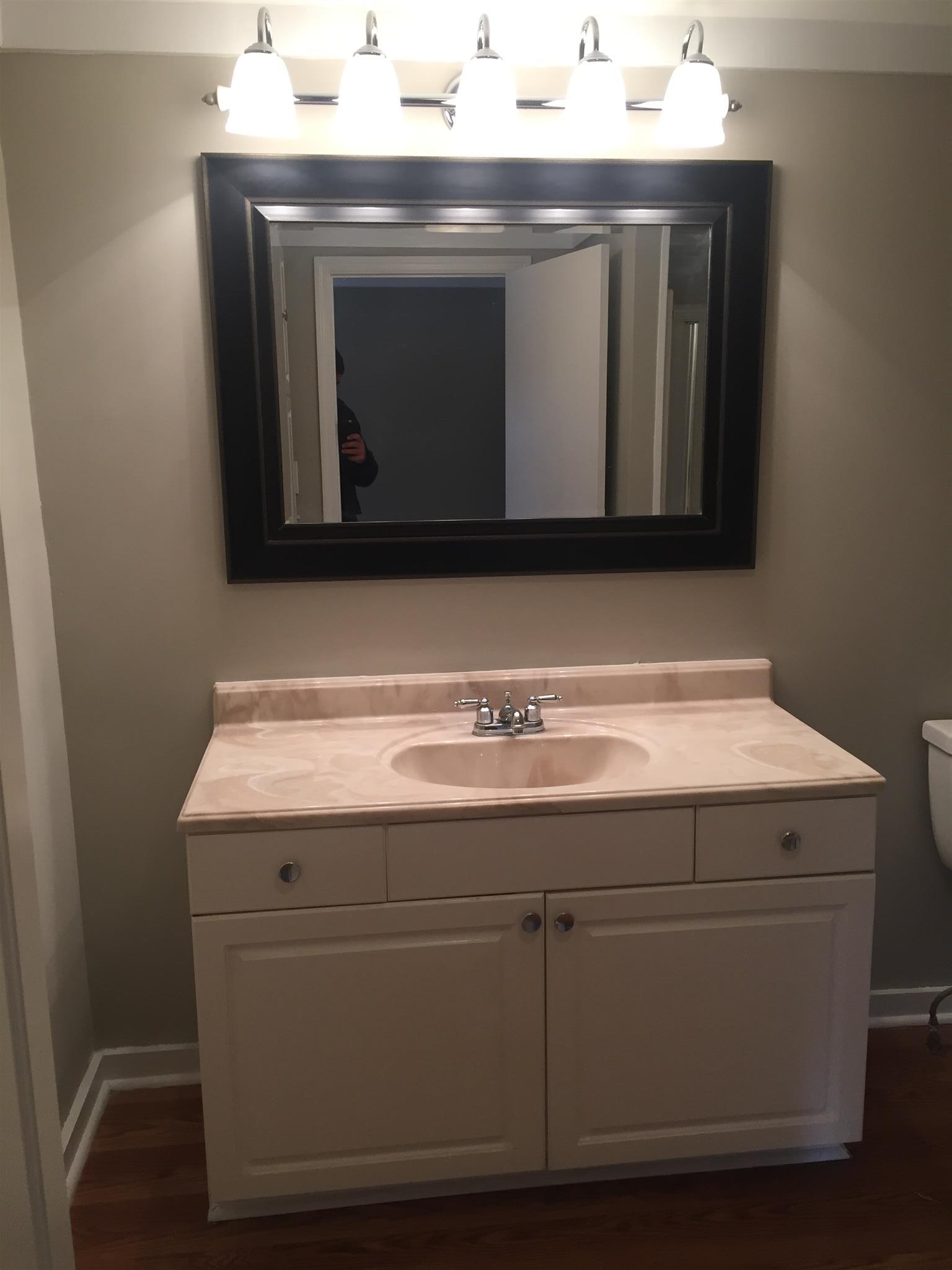 506 Dorris Road Portland, TN 37148 - Photo 7 of 8 a utility room with a sink and a mirror