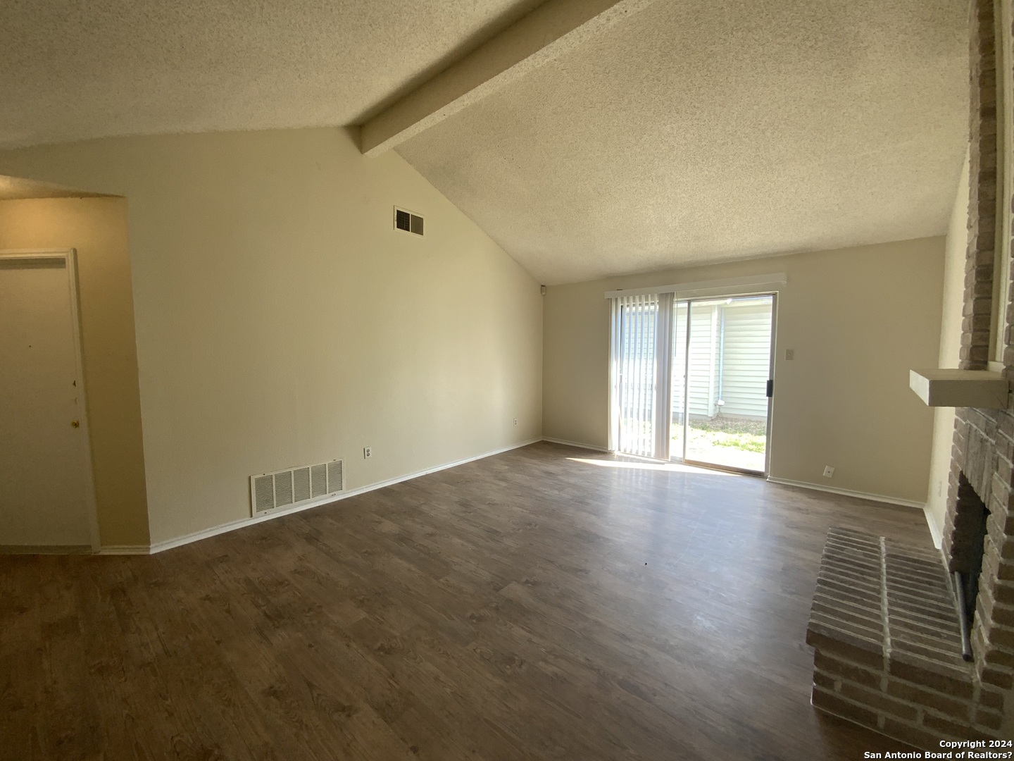 10126 Galesburg San Antonio, TX 78250 - Photo 5 of 17 an empty room with wooden floor and windows