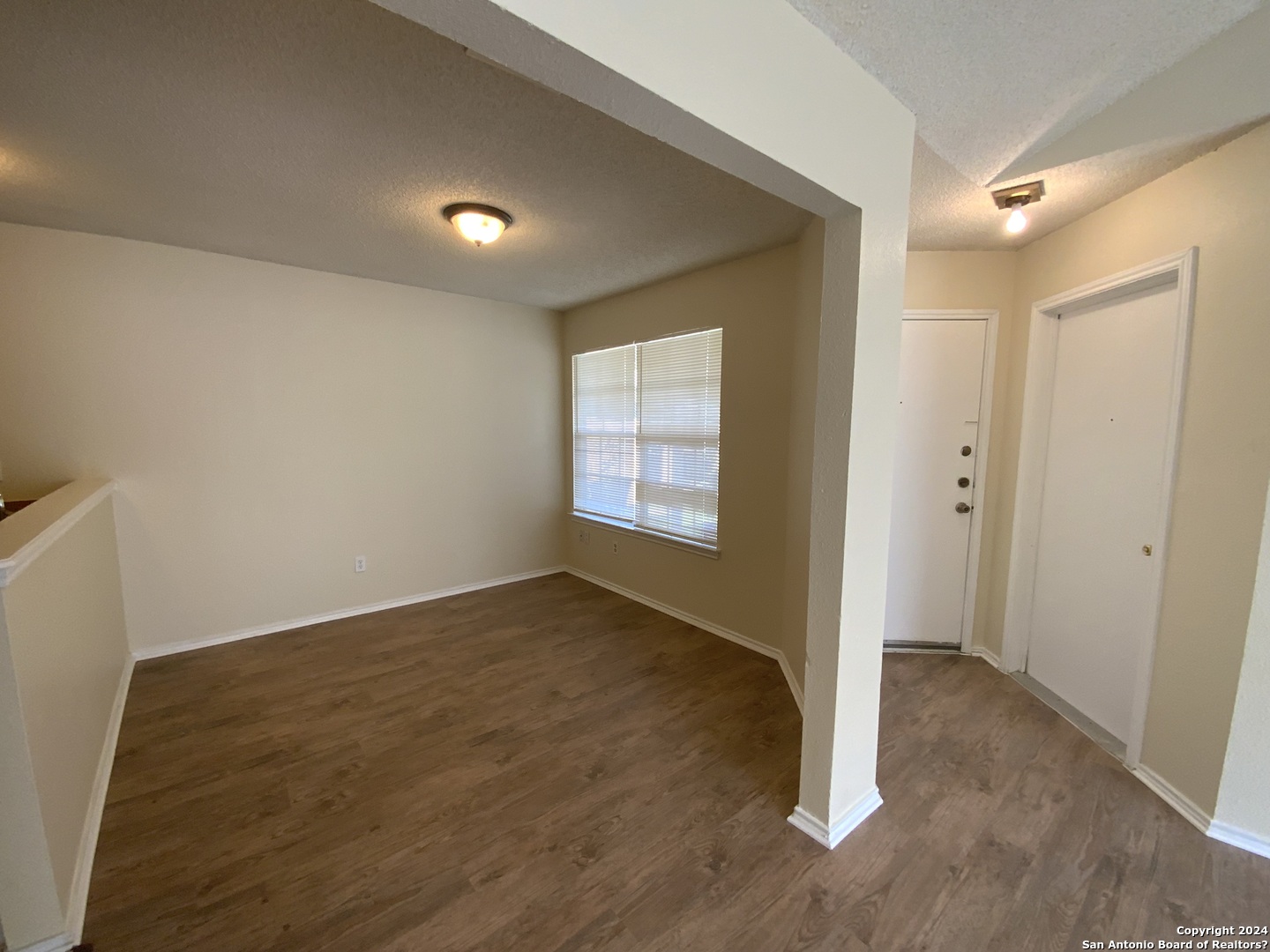 10126 Galesburg San Antonio, TX 78250 - Photo 7 of 17 an empty room with wooden floor and windows