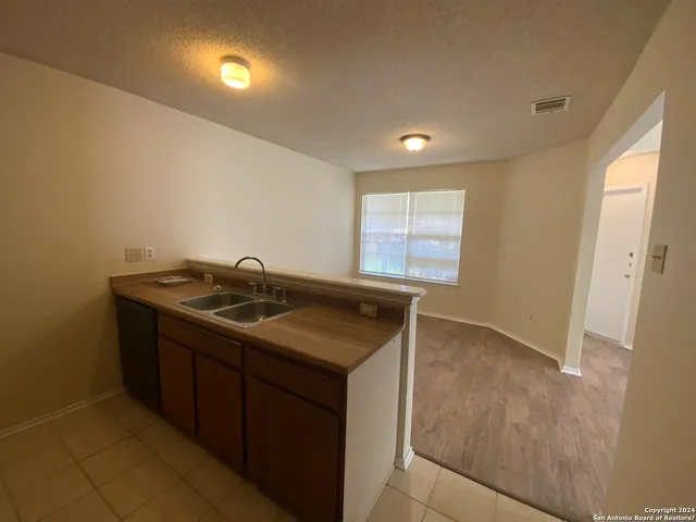 a kitchen that has a sink and a stove