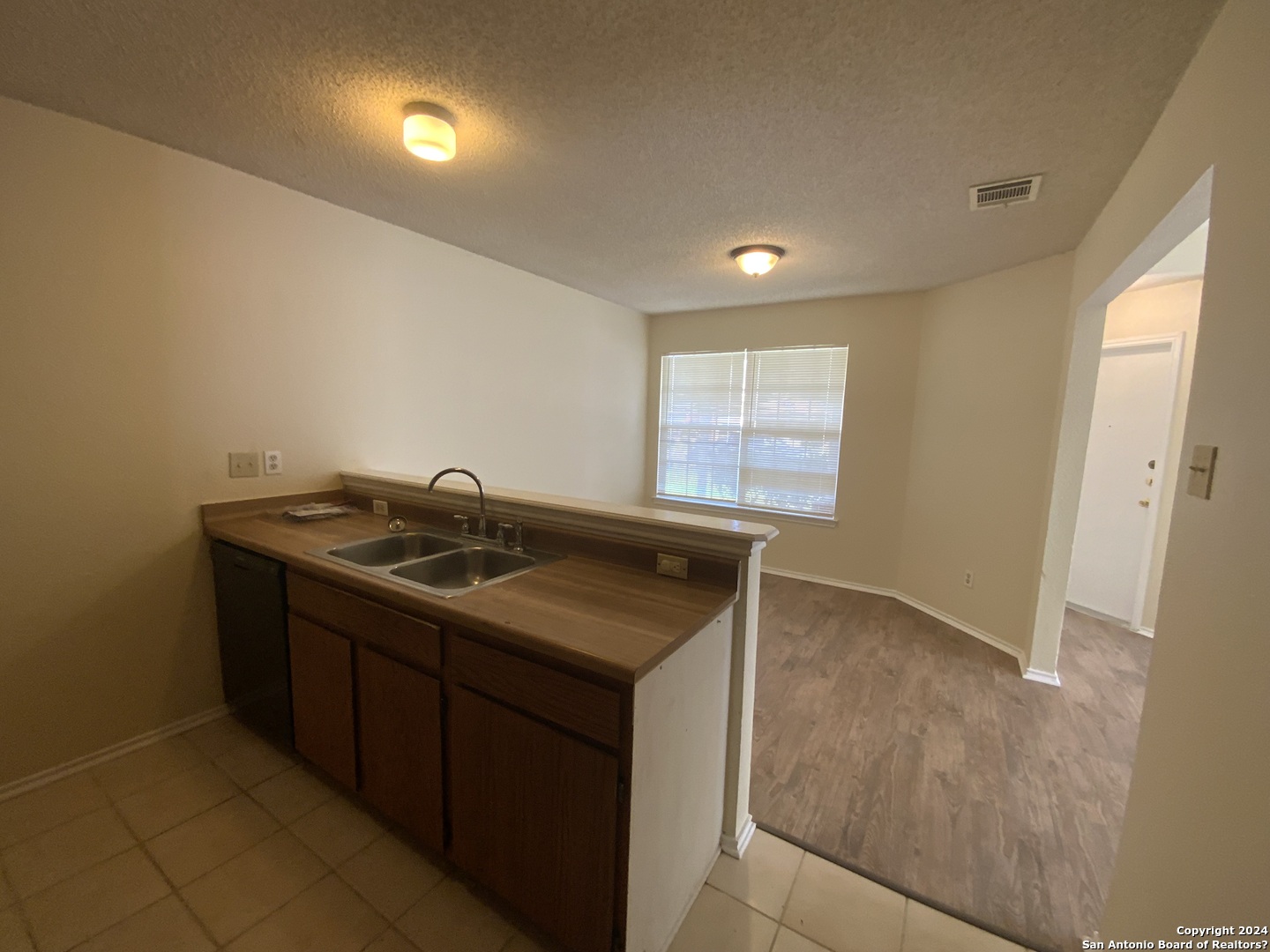 10126 Galesburg San Antonio, TX 78250 - Photo 9 of 17 a kitchen that has a sink and a stove