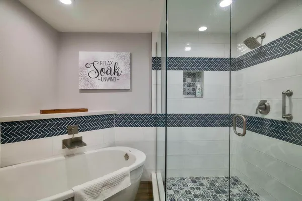 a bathroom with a bathtub and shower