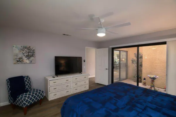 a bedroom with furniture and flat screen tv