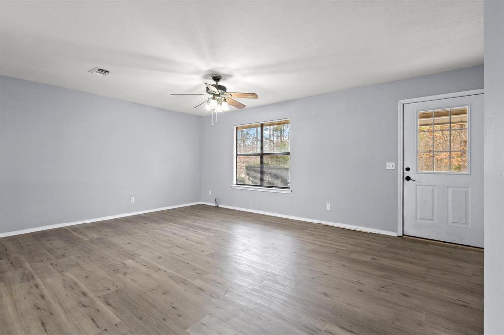 206 County Road Powderly, TX 75473 - Photo 4 of 31 wooden floor in an empty room with a window