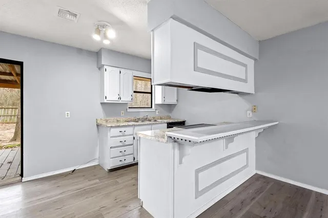 a kitchen with stainless steel appliances granite countertop a stove and a refrigerator