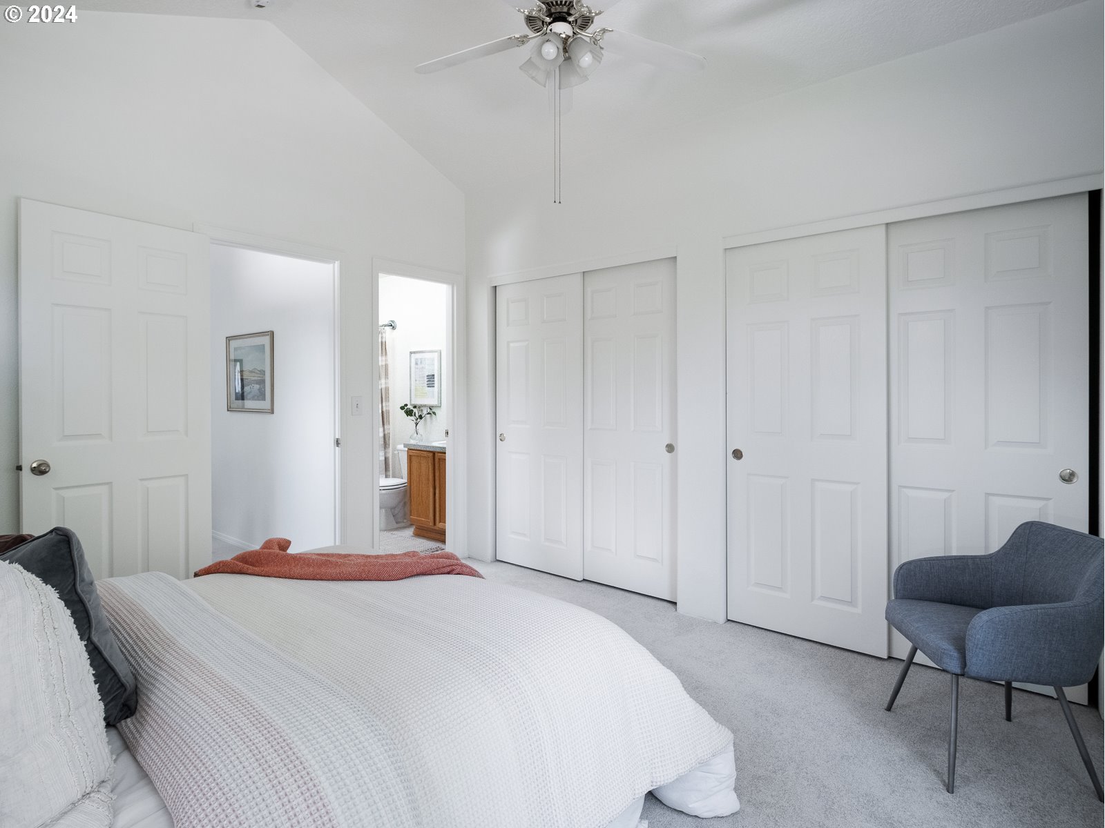 5541 Southeast Henderson Street Portland, OR 97206 - Photo 12 of 26 a bedroom with a bed a chair and a chandelier