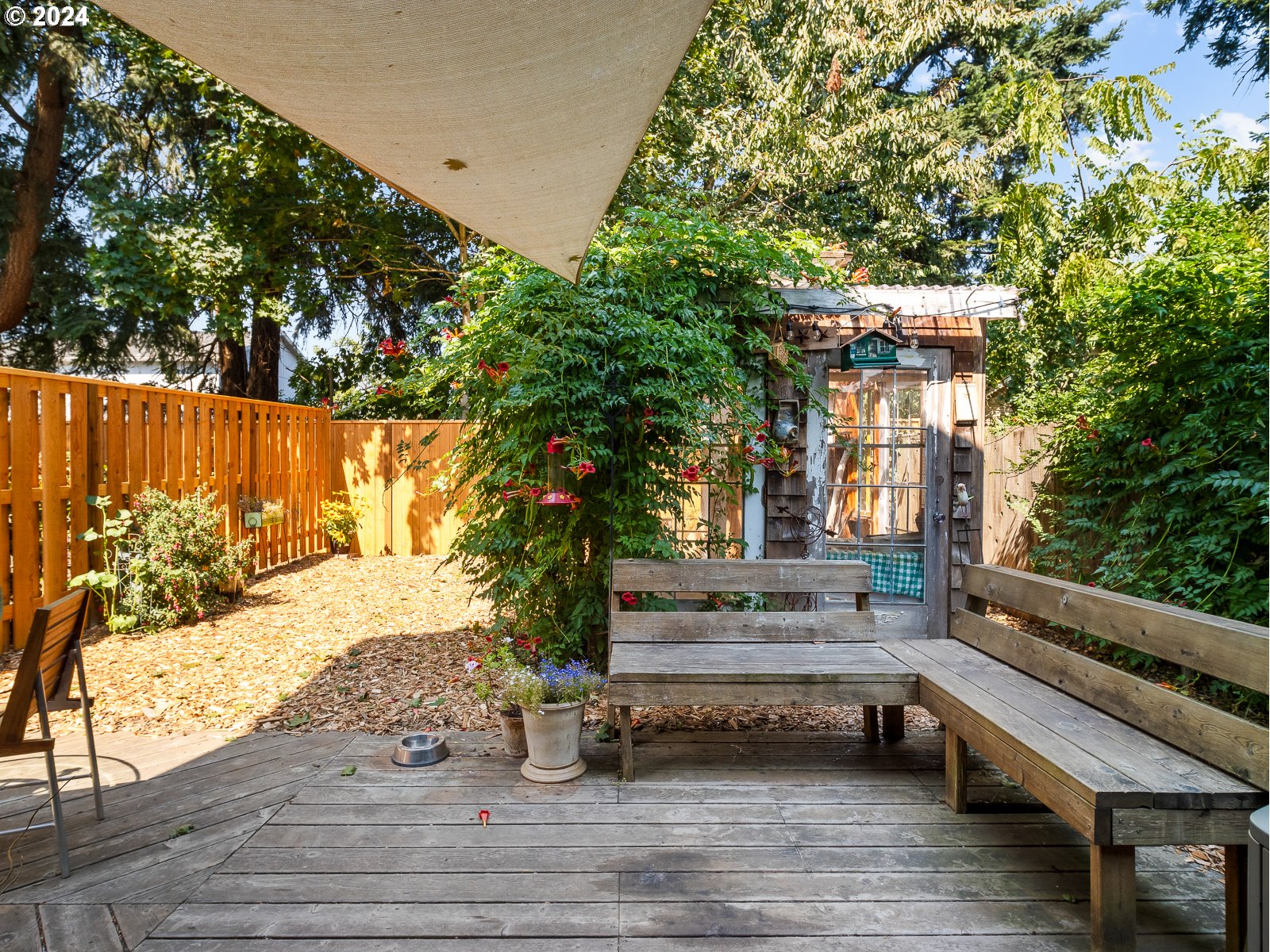 5541 Southeast Henderson Street Portland, OR 97206 - Photo 19 of 26 a view of backyard with wooden fence and large trees