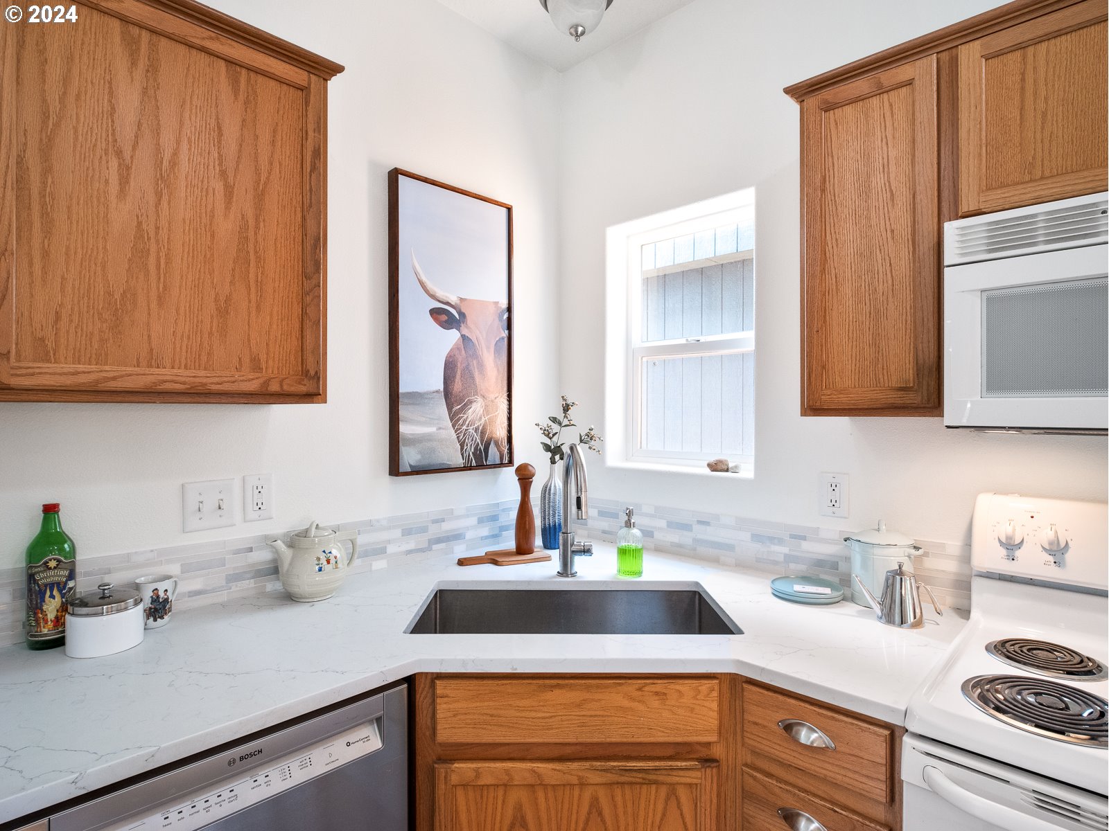5541 Southeast Henderson Street Portland, OR 97206 - Photo 6 of 26 a kitchen with stainless steel appliances granite countertop a sink stove and cabinets