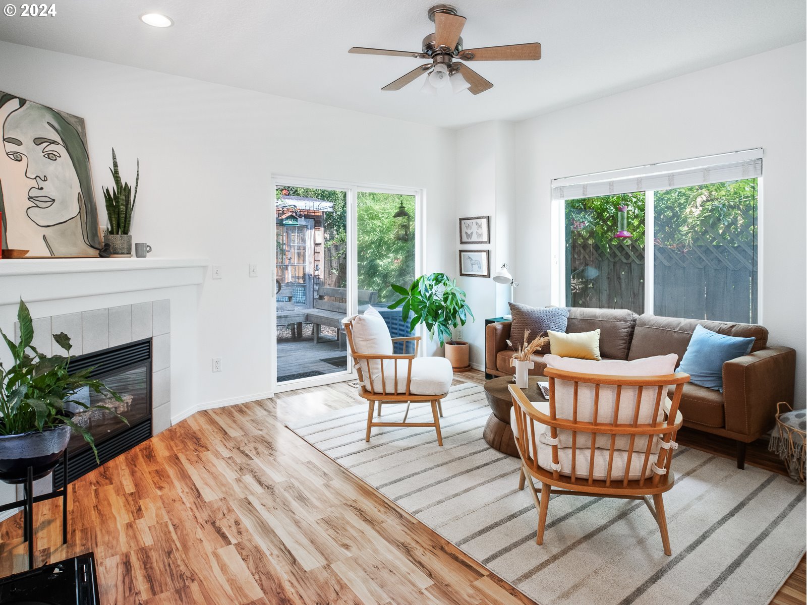 5541 Southeast Henderson Street Portland, OR 97206 - Photo 8 of 26 a living room with furniture a fireplace and a potted plant
