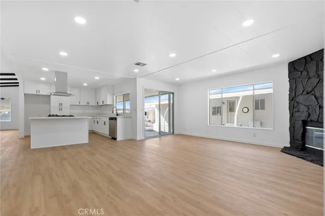 a view of wooden floor fireplace and window in a room