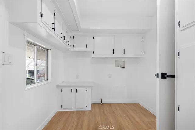 an empty room with wooden floor and a window