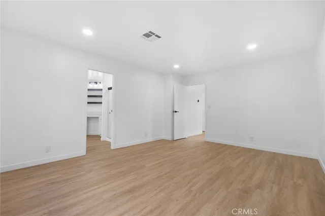a kitchen with white cabinets and window
