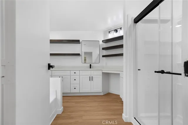 a kitchen with white cabinets and sink
