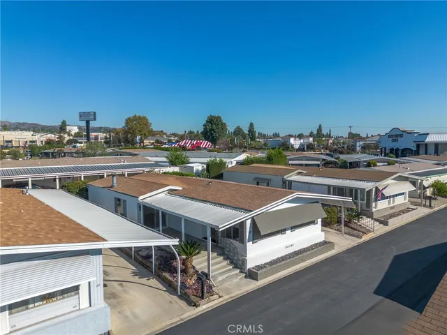 a view of swimming pool with outdoor seating and plants